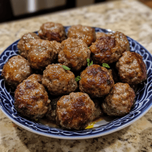 A plate of gluten-free meatballs made with lean ground meat, herbs, and spices, served with marinara sauce.