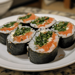 A plate of freshly made negitoro sushi rolls with finely chopped tuna and green onions, served with soy sauce and pickled ginger.