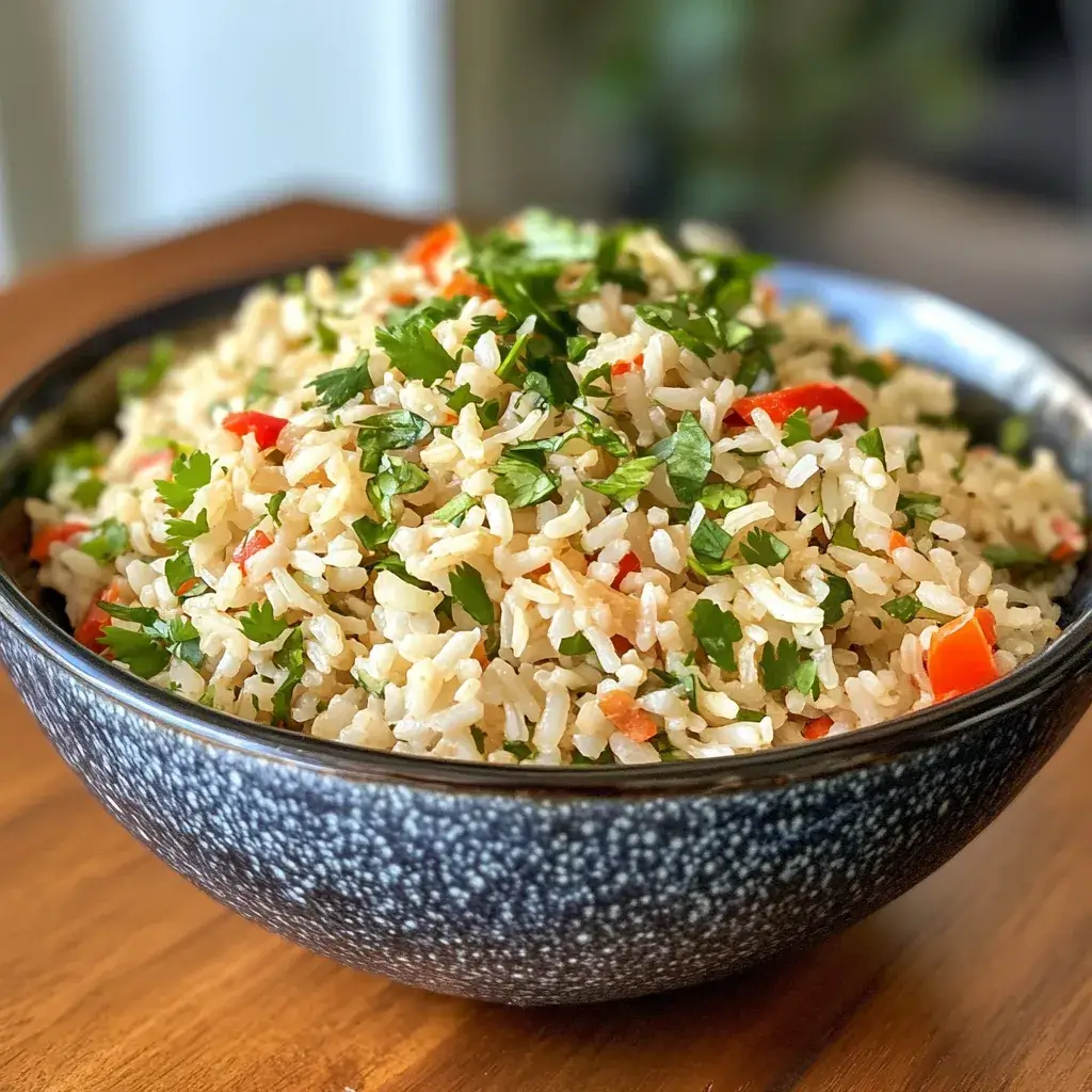 A large pot of Joanna Gaines' Mexican rice served family-style alongside grilled chicken, black beans, and corn salad.