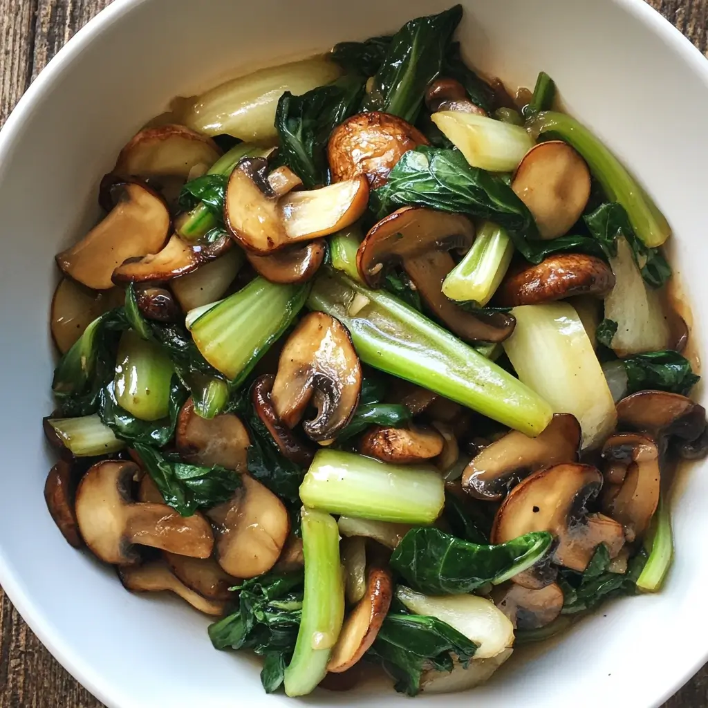 A delicious stir fry with tender bok choy, savory mushrooms, and a flavorful garlic-ginger sauce in a pan.