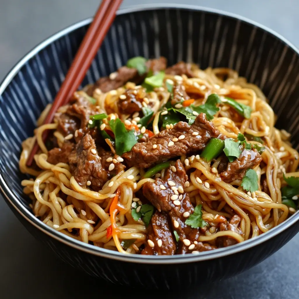 Bowl of Hoisin Beef Noodles with tender beef, vegetables, and flavorful hoisin sauce.